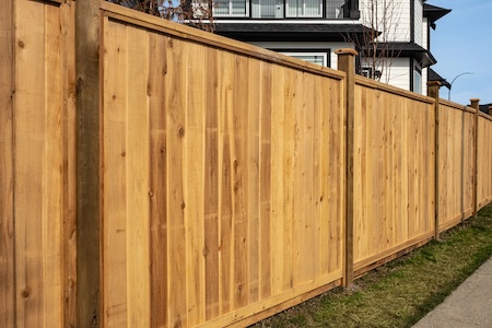 Professional fence cleaning in brownsville restoring gray wood to new